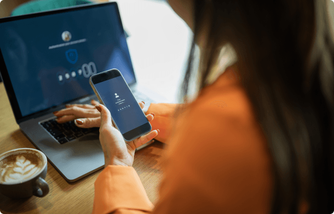 Reviewing security alerts on a laptop and phone